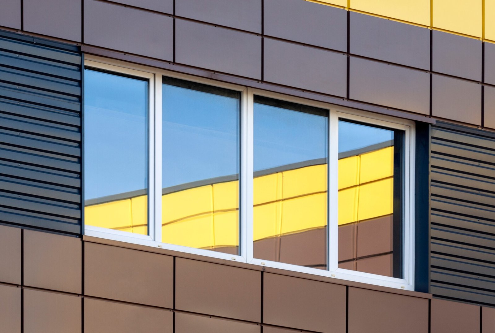 https://familysiding.com/wp-content/uploads/2024/04/i-underroof.com-aluminum-abstract-modern-building-exterior-with-colorful-wi-2025-01-09-02-07-26-utc-scaled.jpg